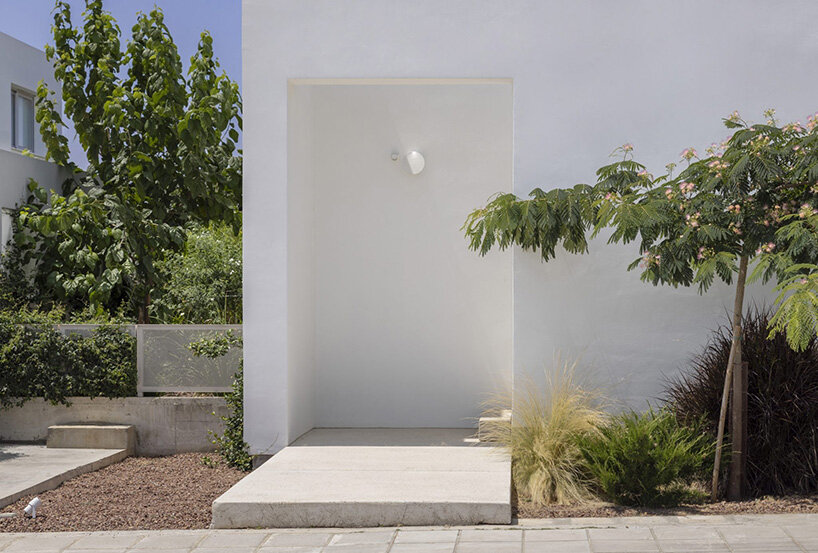 concentric white walls conceal garden-filled residence by draftworks* architects in cyprus