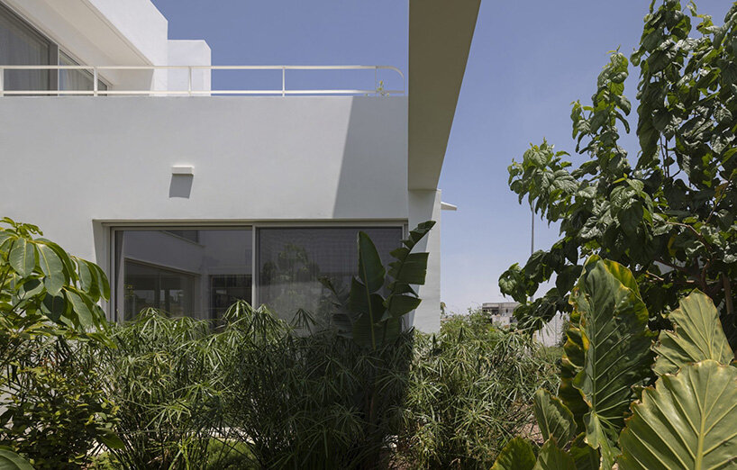 concentric white walls conceal garden-filled residence by draftworks* architects in cyprus