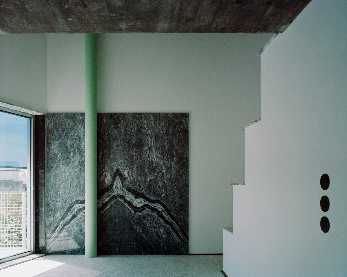 fala atelier inverts the sloped roof with slants and curves for this sculptural home in portugal