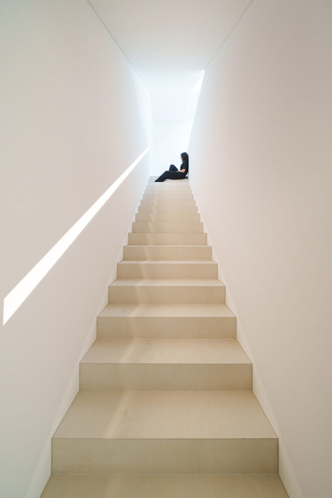 the handrail follows the form of the staircase as a single unbroken line