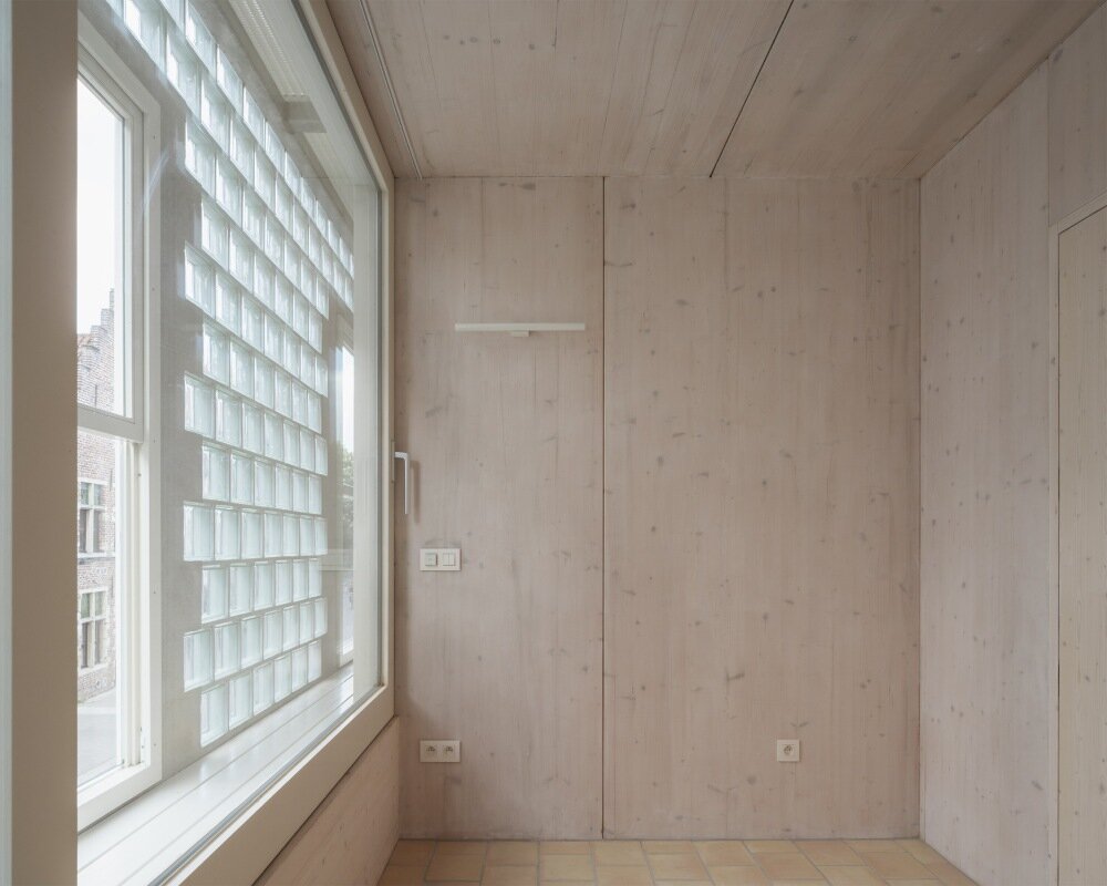 delmulle delmulle's gradient brick facade shifts from terracotta to glass in amsterdam townhouse