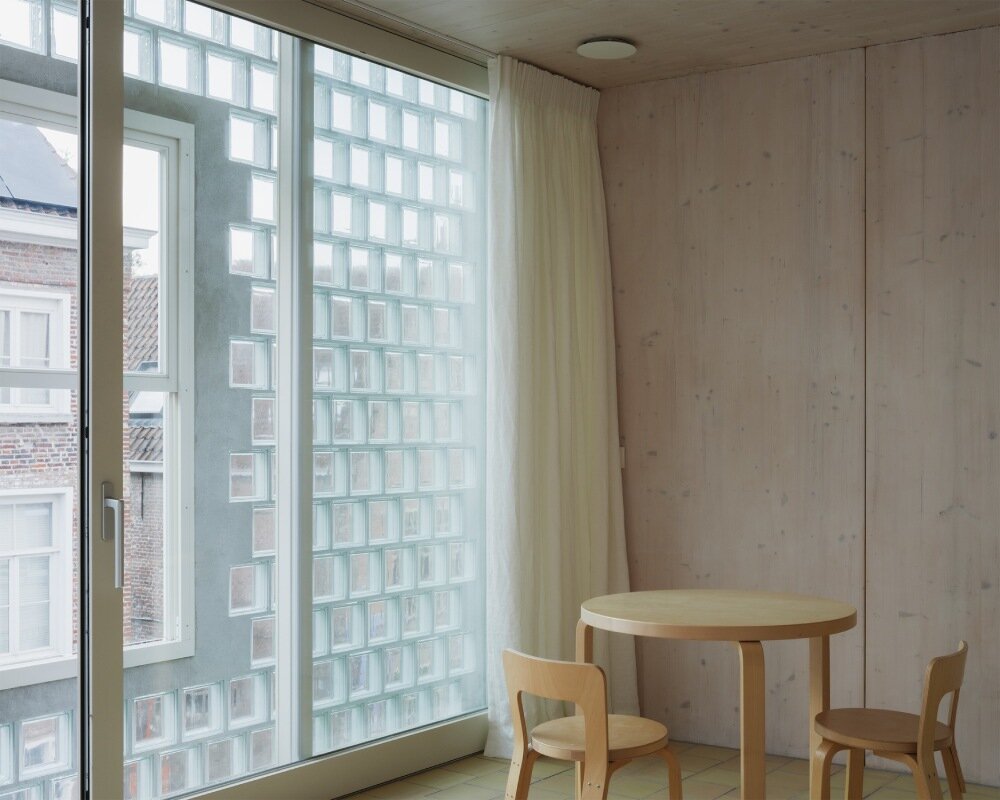 delmulle delmulle's gradient brick facade shifts from terracotta to glass in amsterdam townhouse