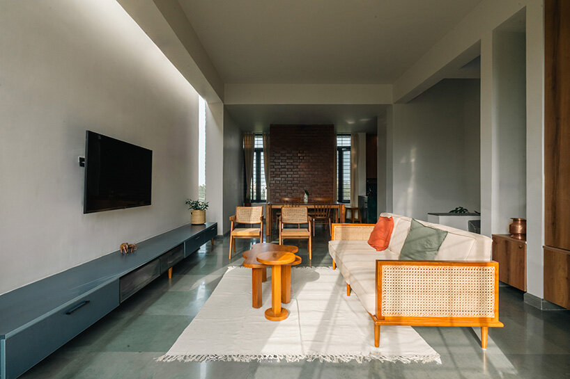 the space opens into a high-ceilinged living and dining area