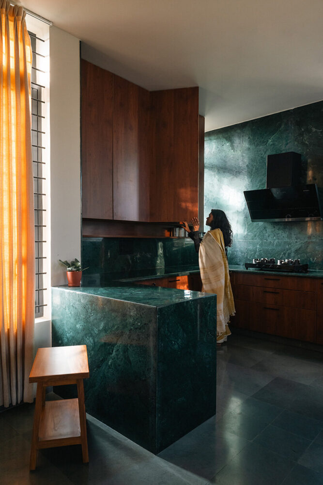 the kitchen is finished in locally sourced green marble and warm wood