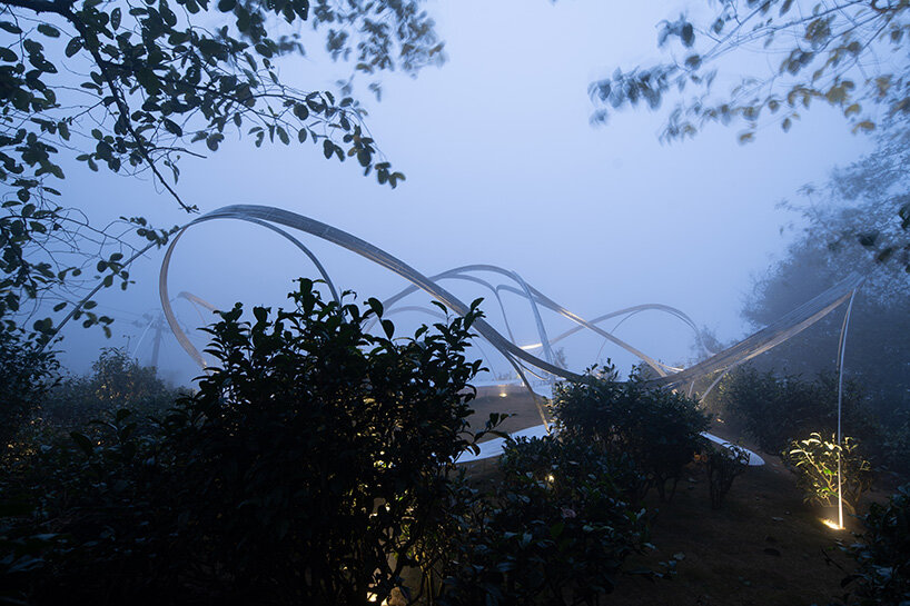 the structure emerges from the mists of Fenghuang Mountain 