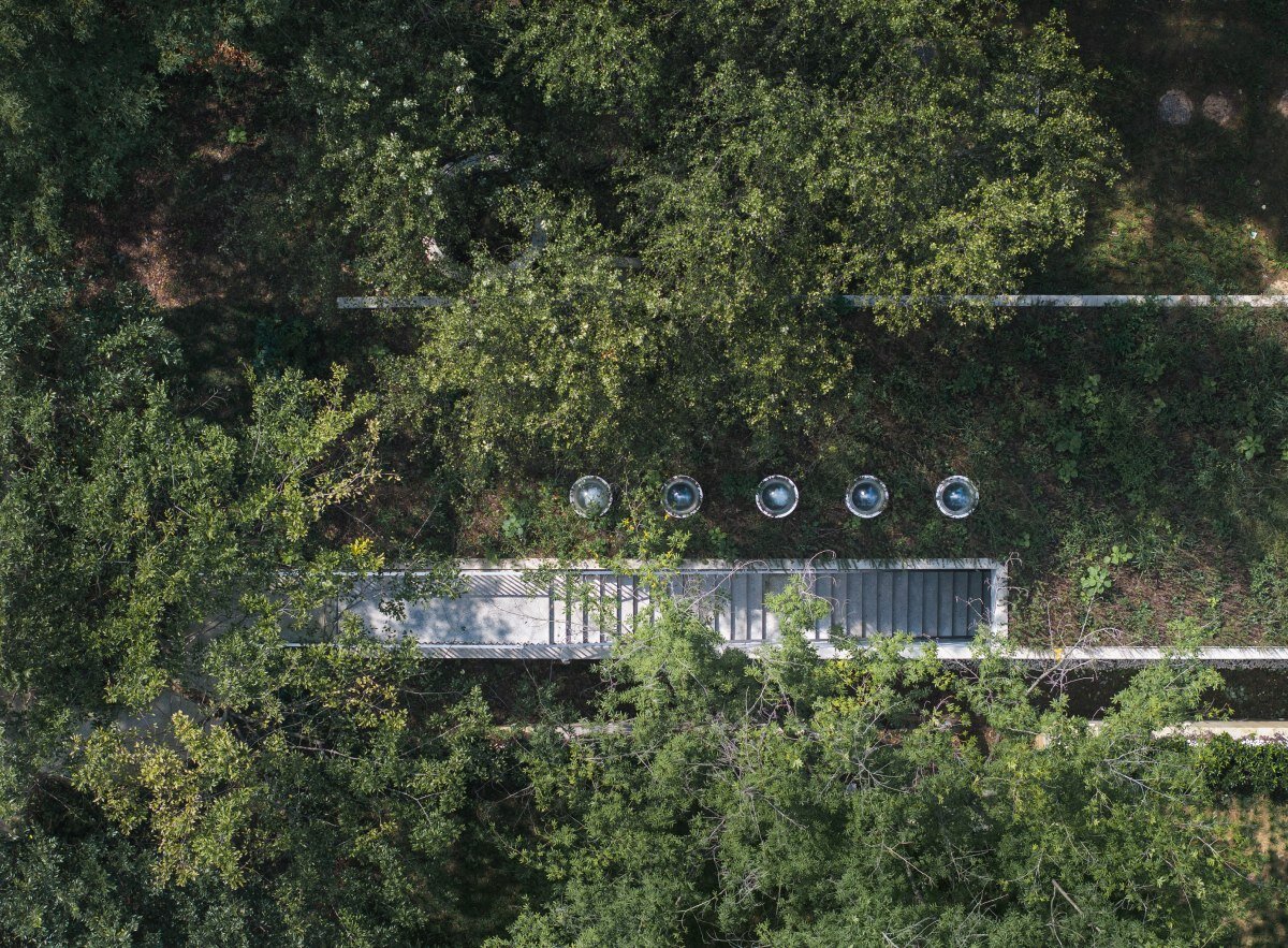 WUWU atelier's restrooms perch like concrete clouds and cavernous crevices in china forest