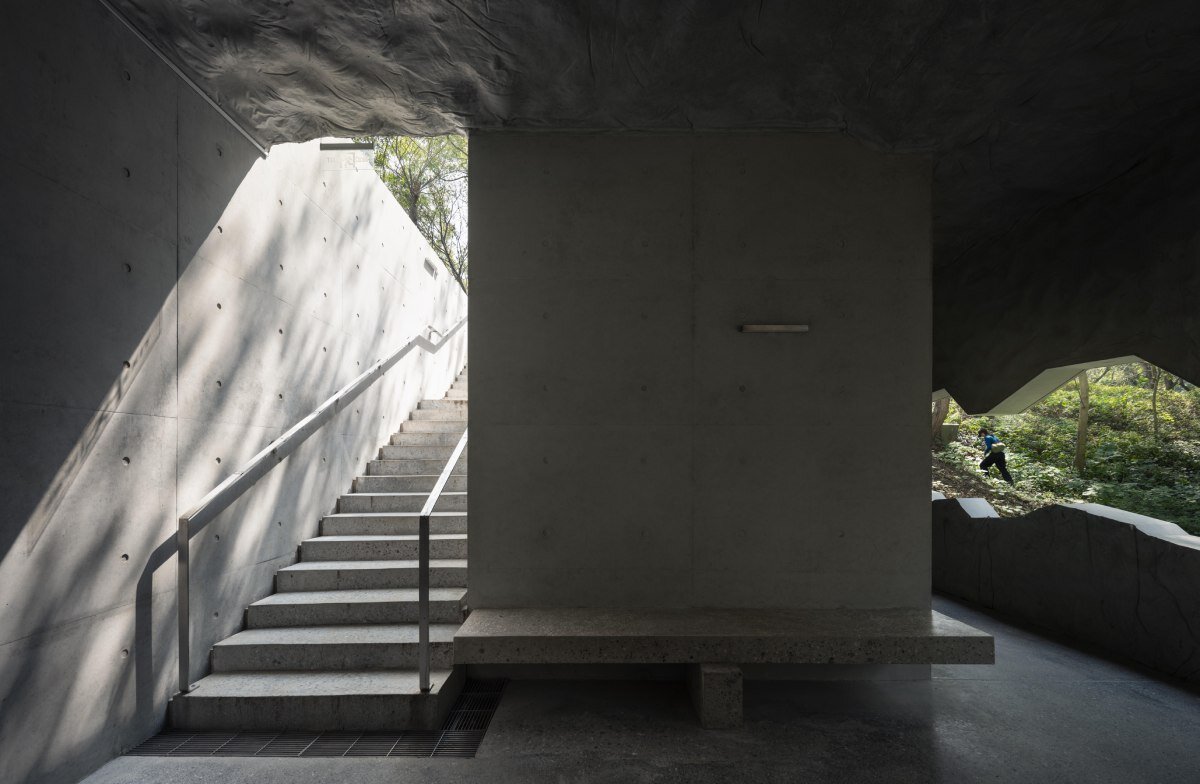 WUWU atelier's restrooms perch like concrete clouds and cavernous crevices in china forest