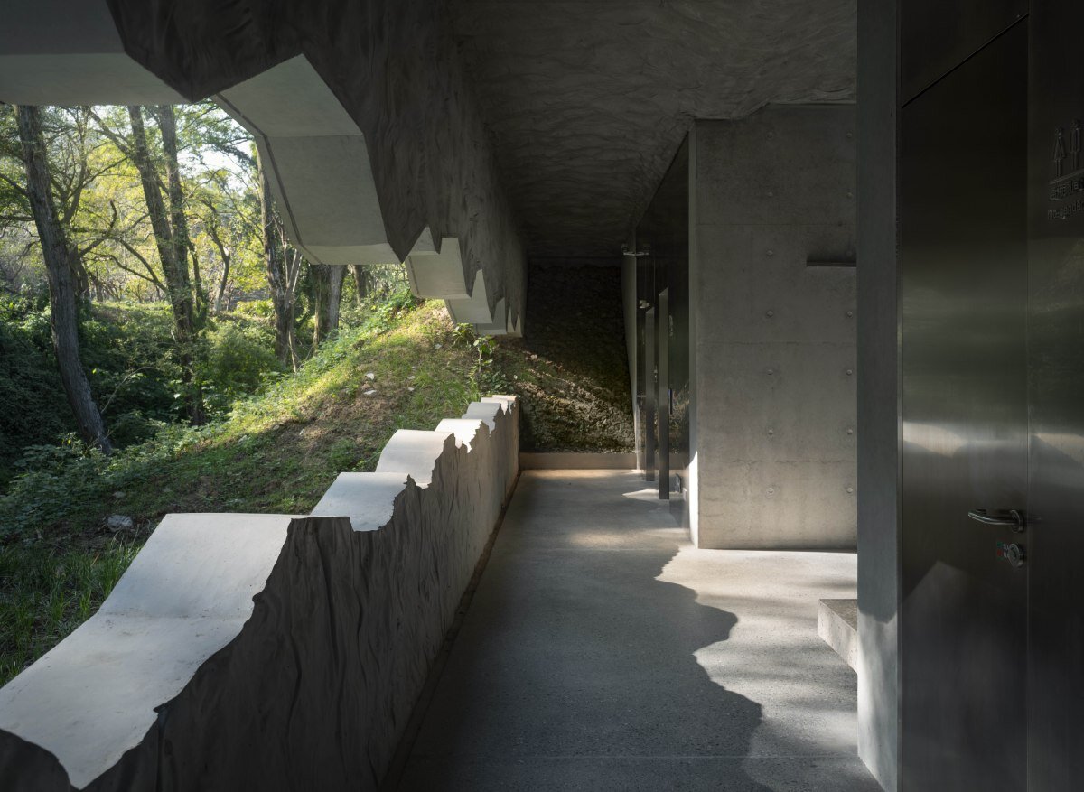 WUWU atelier's restrooms perch like concrete clouds and cavernous crevices in china forest