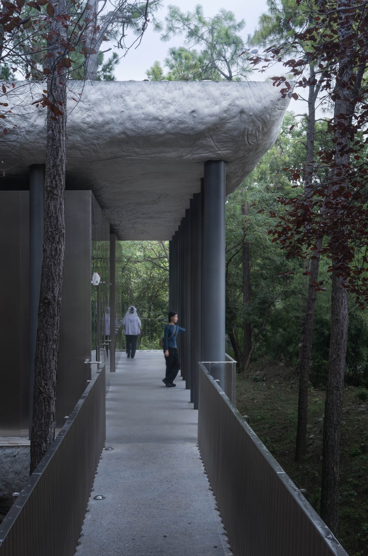 WUWU atelier's restrooms perch like concrete clouds and cavernous crevices in china forest