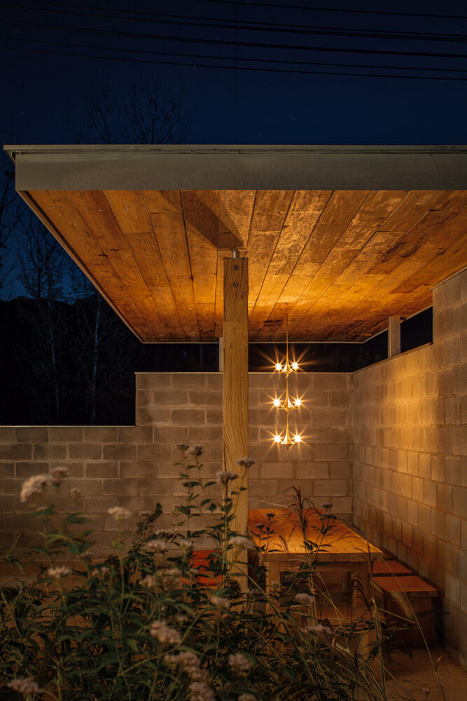 a cantilevered roof defines a recessed area open to landscape views