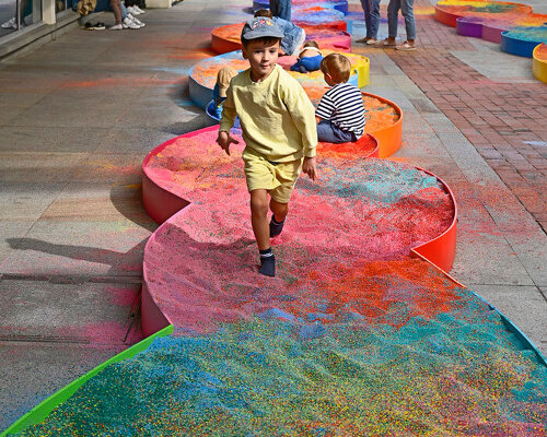tons of colored aggregates mix together to form color path public art installation in poland