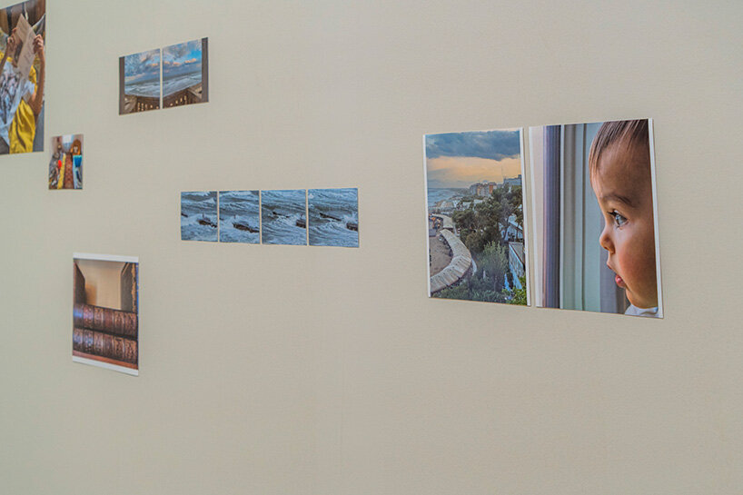 small-scale photographs line the walls | image ©Andreas Simopoulos