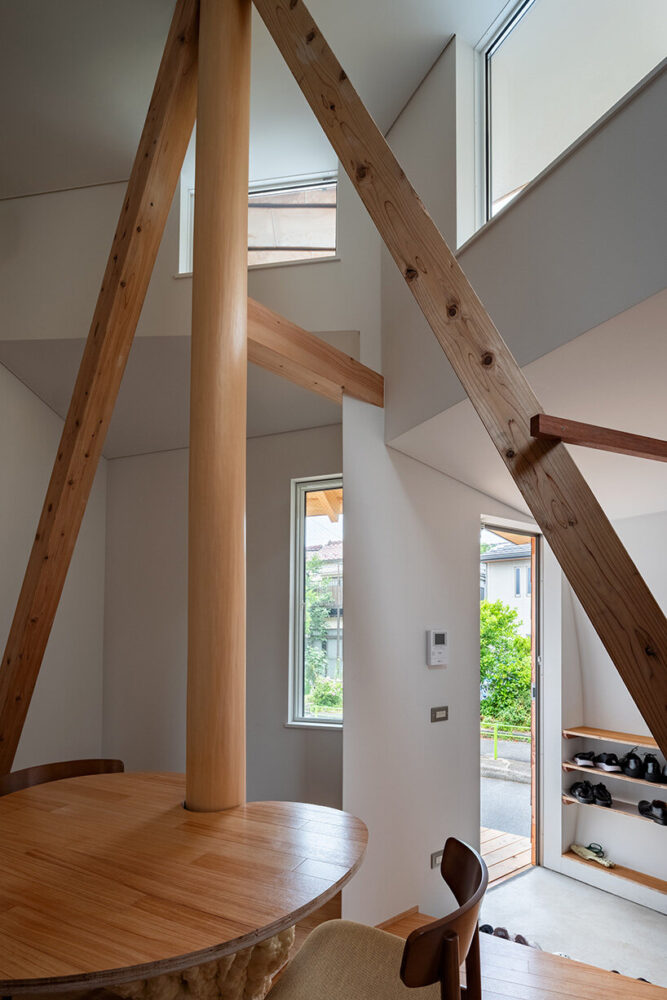 wooden beams and openings frame shifting views of the surrounding greenery