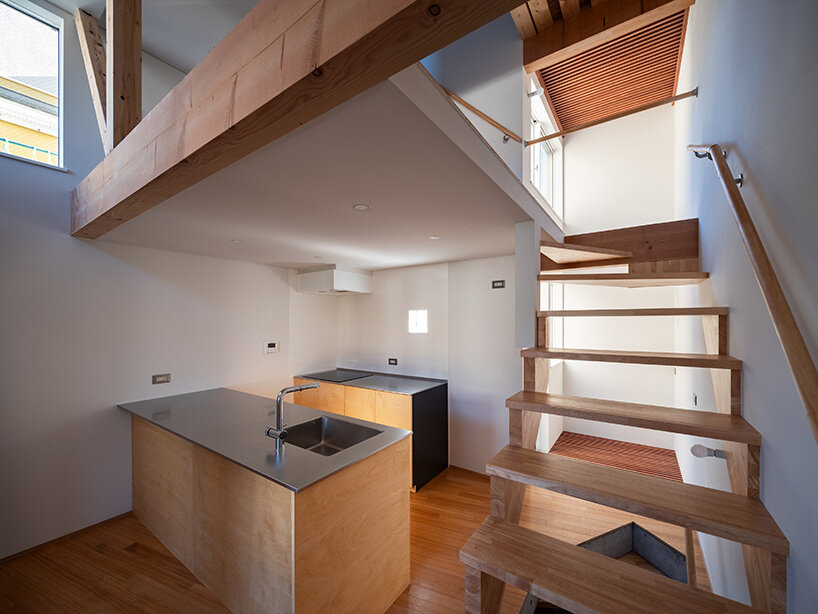 the kitchen and staircase connect vertically through open, light-filled volumes