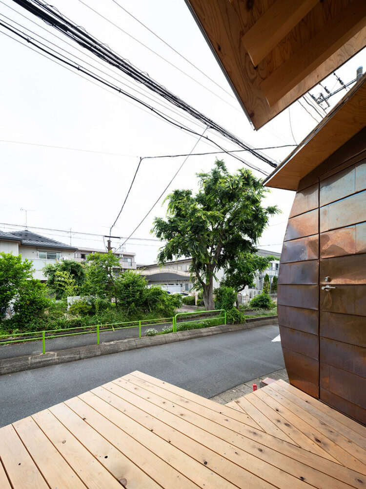 a small front terrace extends the greenery of the adjacent walkway