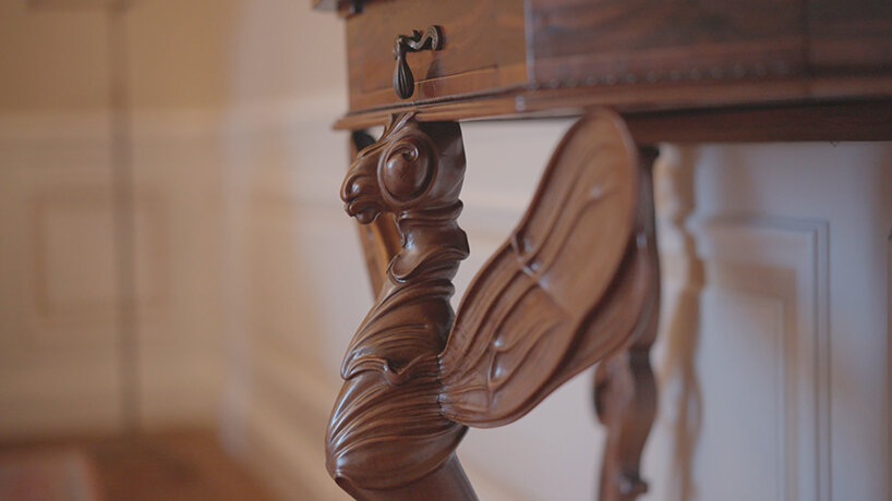 furniture adorned with sculpted insects can be found within the interiors