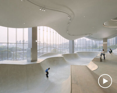 curved urban skatepark set within floating glass volume overlooks shanghai’s skyline
