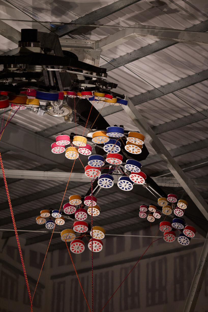 each arm carries a spool with fibers, twisted and woven together to form a long rope | image by The Wick