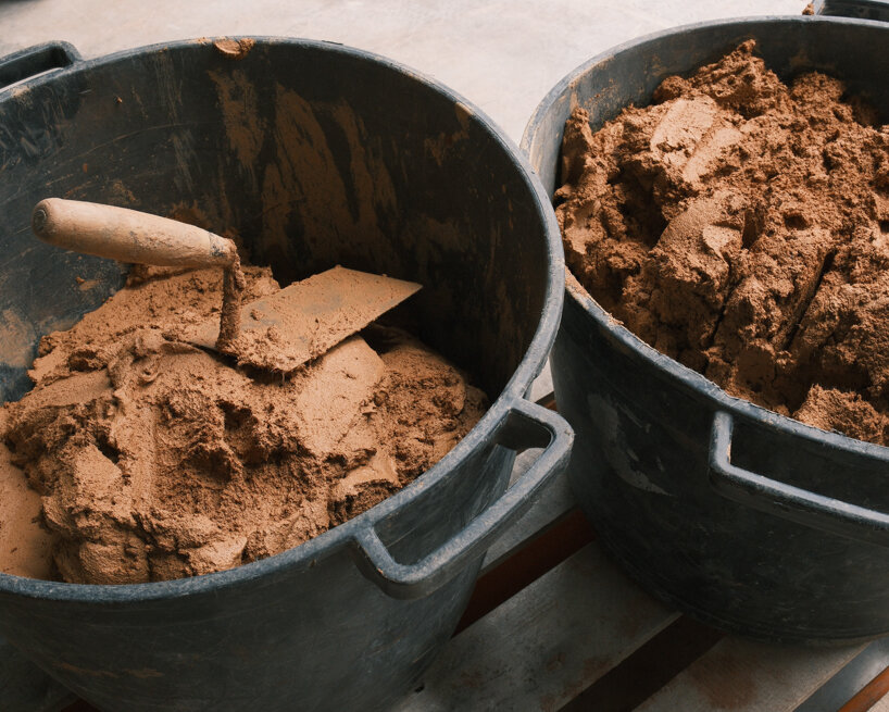 a local soil-based mixture, composed of soil, clay, sand, fibers, and bio-based additives, is blended to achieve optimal properties for 3D printing