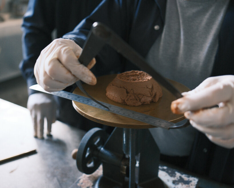 researchers evaluate the workability and consistency of soil-based mixture to ensure printability for robotic extrusion