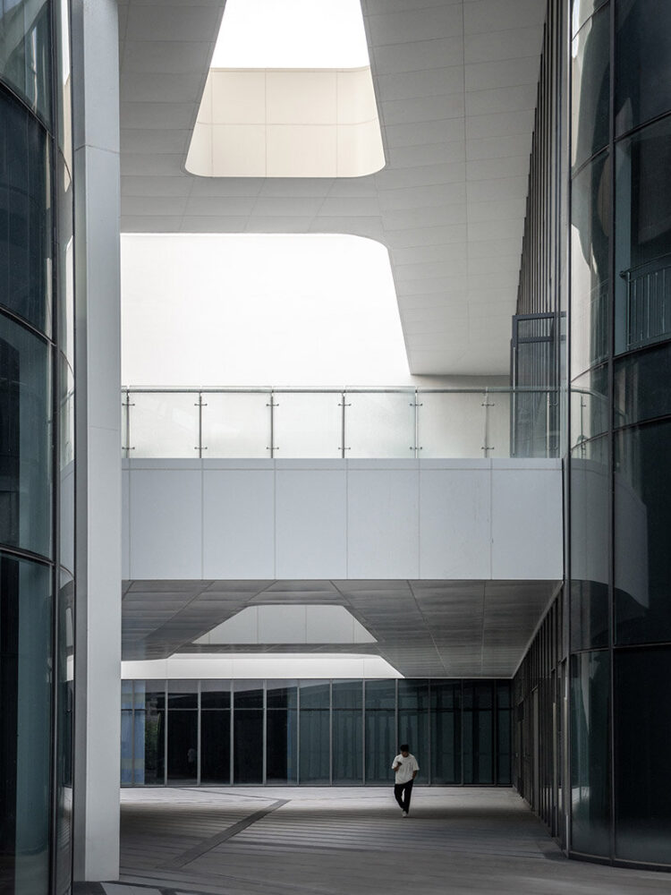 a central atrium acts as an interior urban street linking all major volumes