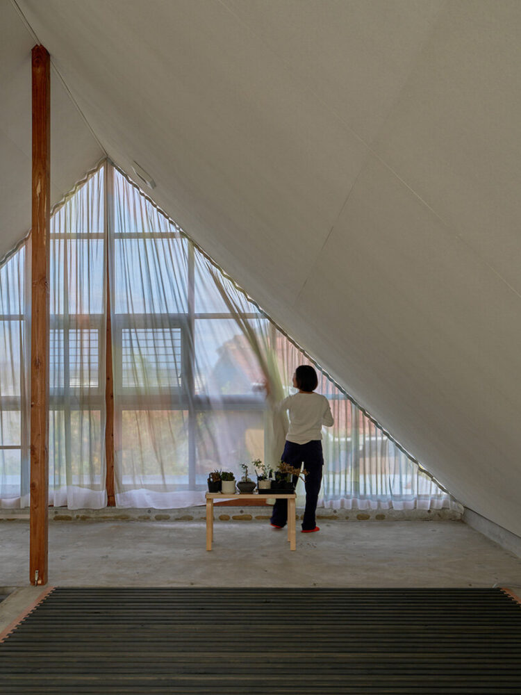 framing views of the neighborhood’s tiled rooftops and the surrounding mountains