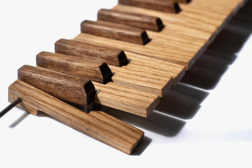 the walnut is used for the edges and black keys, while the oak is used for the white keys