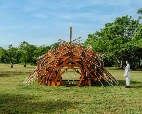 interlocking bamboo and cedar frames shape wild boar nest installation by cheng tsung feng