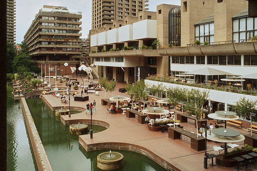 a lawn dotted with picnics and a small playground softens the geometry