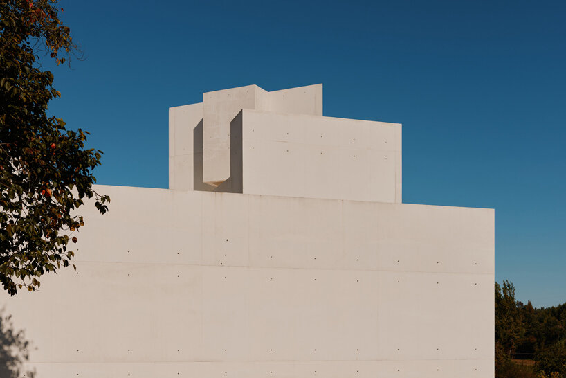 the sharp, upward-pointing geometry of the white-concrete extension