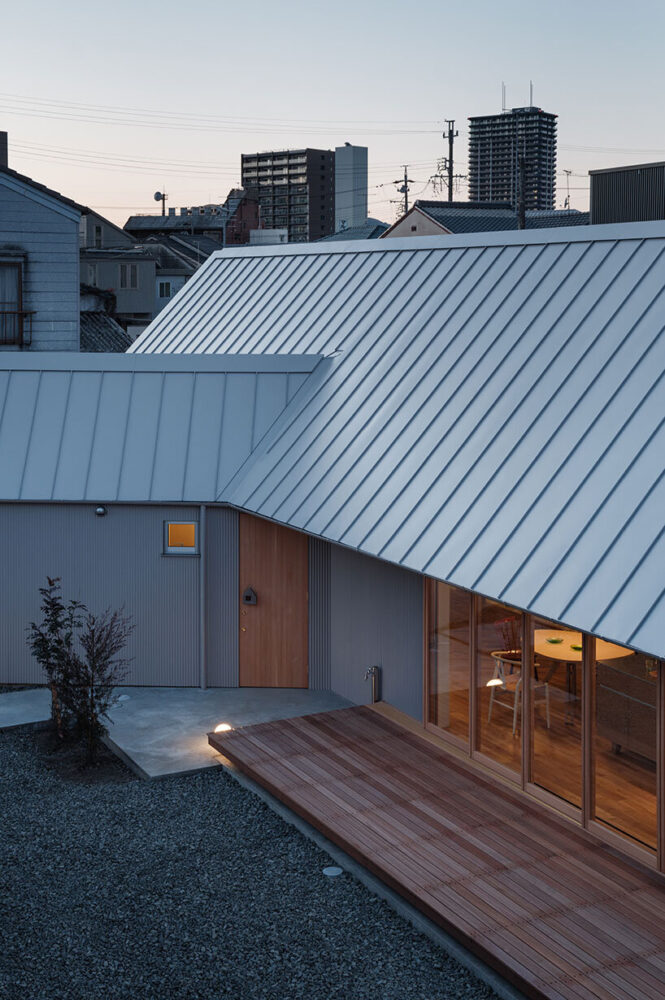 the main volume and secondary wing form a T-shaped arrangement