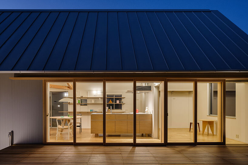 at dusk, the large openings transform the residence into a glowing lantern