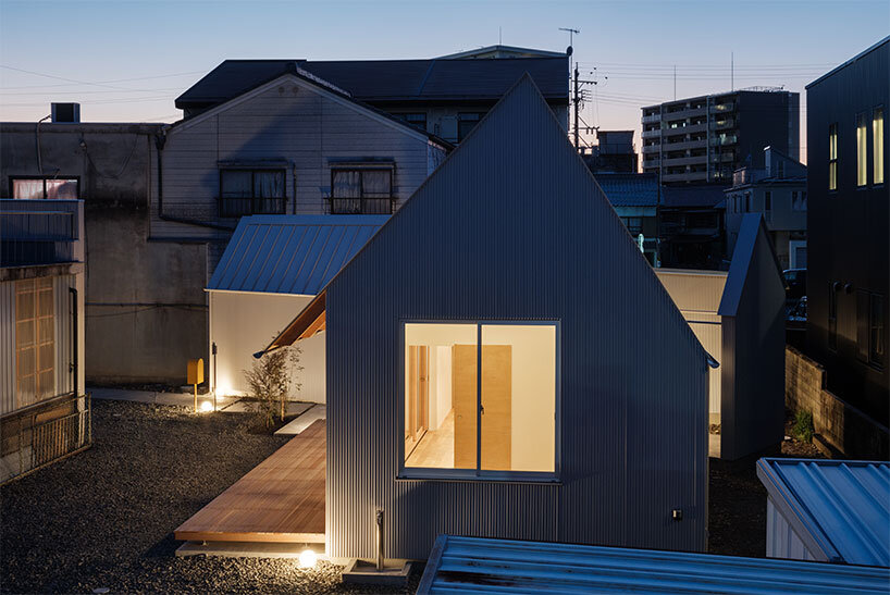artificial light spills from the glass doors and openings