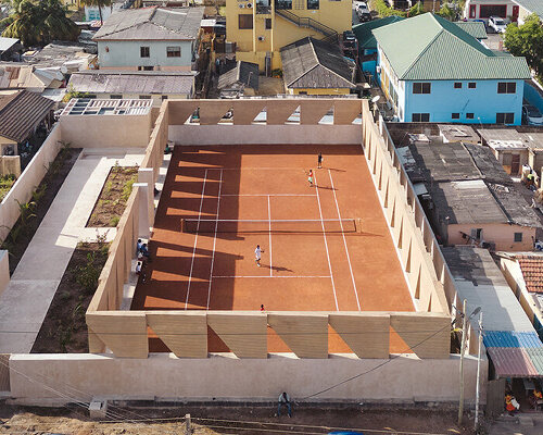 ghana’s first precast rammed earth project by deroche projects hosts community tennis court