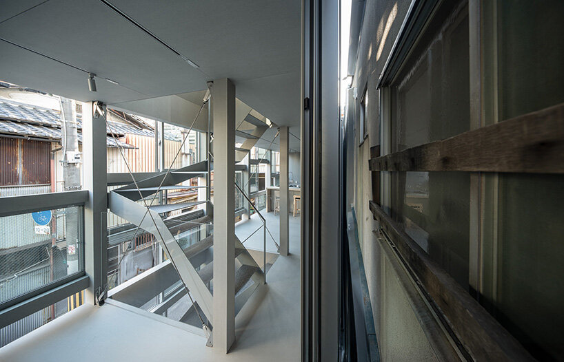 sliding windows and narrow gaps between buildings create subtle layers