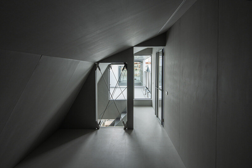 a slanted wall on the third floor acts as a structural support