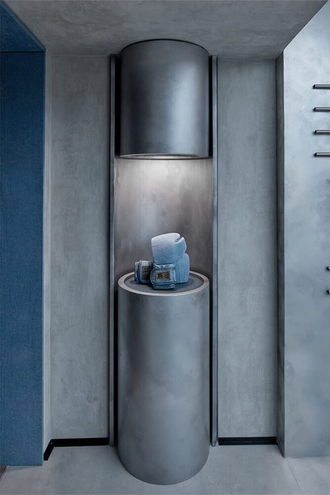 a silver pedestal showcases the denim gloves