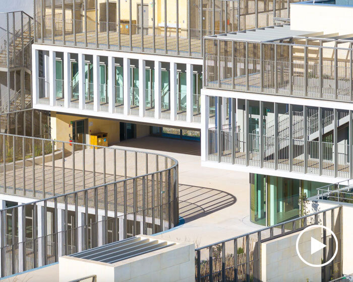 interlocking stone volumes sculpt layered school complex by brenac & gonzalez & associés