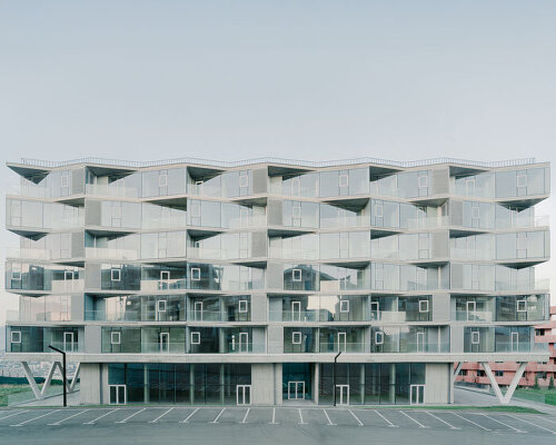 prismatic glass facade enfolds residential unit’s concrete modular framework in georgia