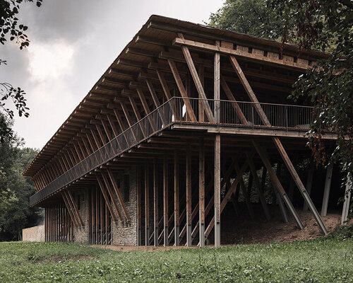 local stone and timber shape self-sufficient riverbank house by BC architects in belgium