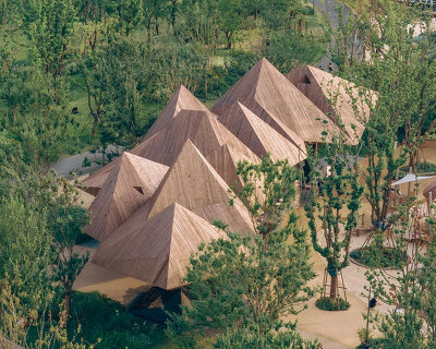 pyramidal volumes with wood strip patterns frame luxeisland restaurant by DL atelier