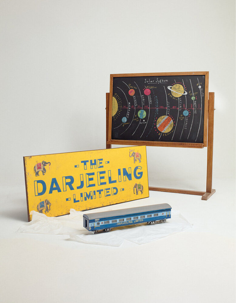 Miniature model and sign of the train, THE DARJEELING LIMITED, and blackboard depicting the Solar System, ASTEROID CITY. Photo Richard Round-Turner. © the Design Museum