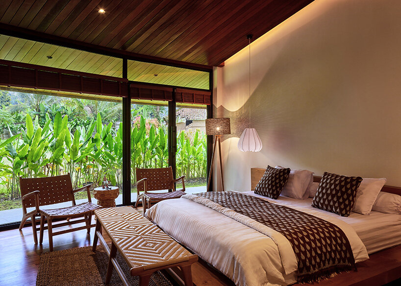 the bedroom opens directly onto the surrounding tropical garden