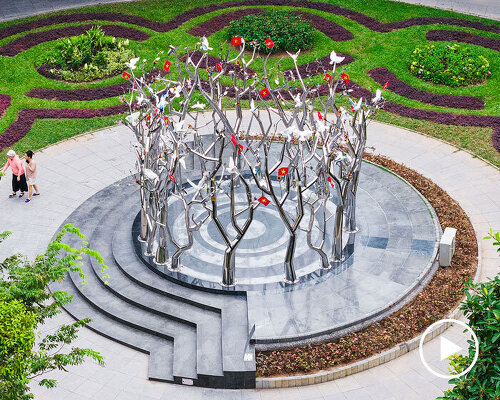 a circle of mirroring steel branches composes a luminous forest in hanoi’s public realm