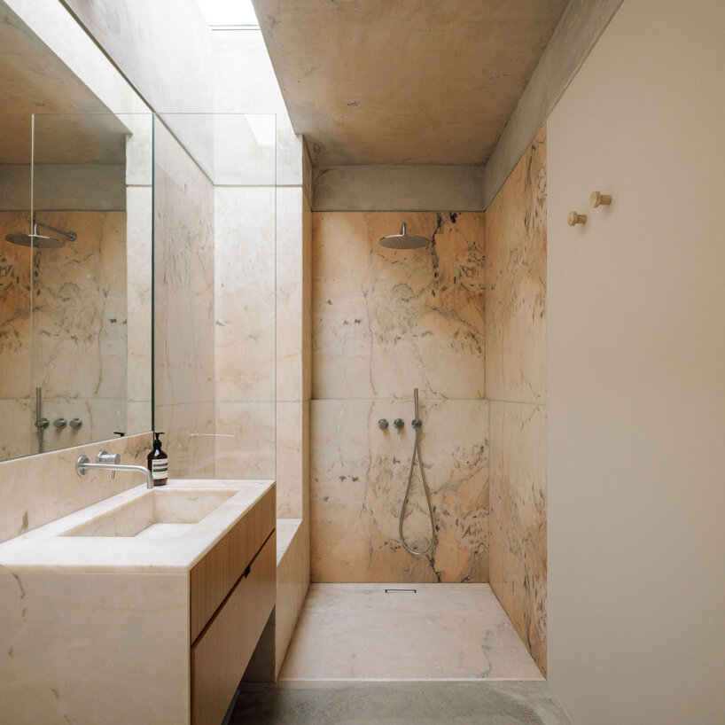 the bathroom is characterized my marble surfaces