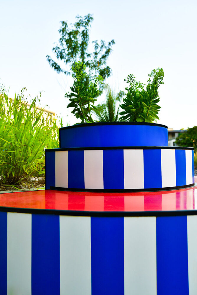 the benches and planters introduce a playful cadence into the urban fabric