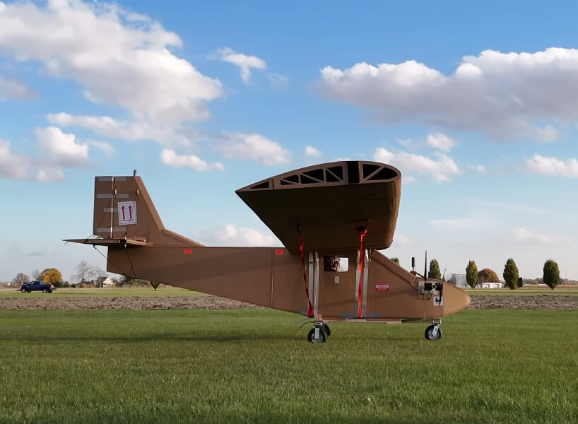 cardboard airplane with wooden wings takes flight using remote control