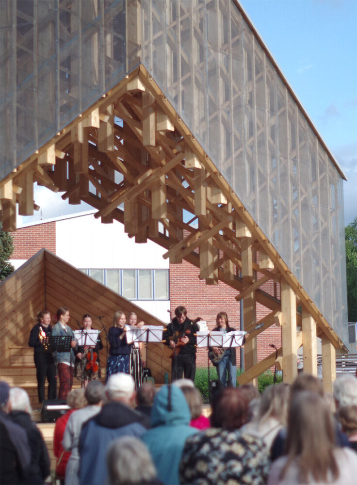 residents embrace Kide and invite people to gather under the warm wooden canopy