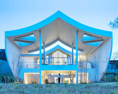 curved eave roofs shape IROJE KHM’s white lakeside residence in south korea