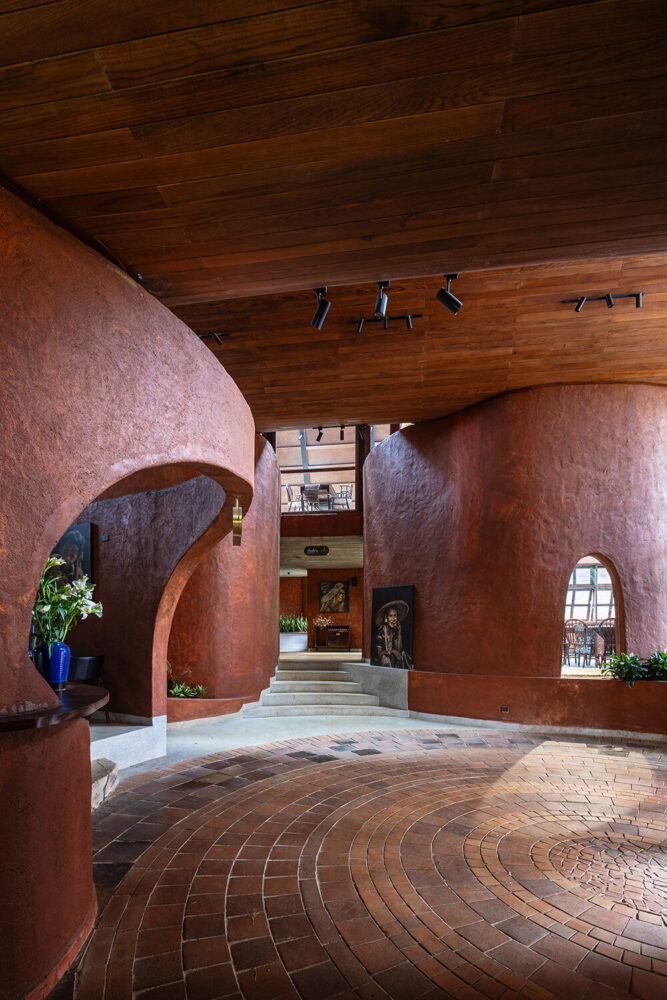 deep red plaster walls reference the region’s basalt-rich soil